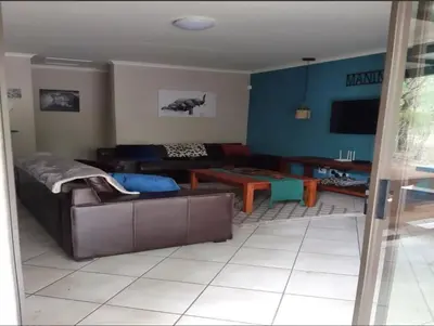 a living room with a couch and a table at Maningwe in Marloth Park