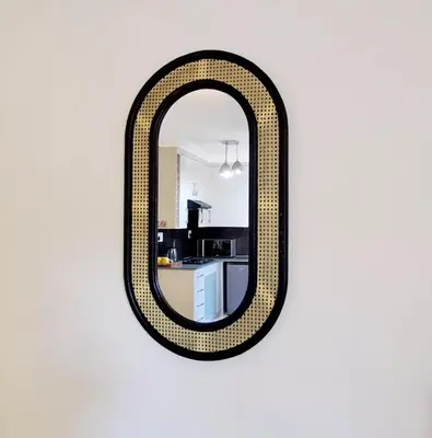 a mirror hanging on a wall with a kitchen at Waterfall City Guest Lodge in Sandton