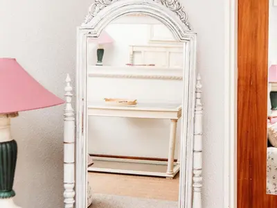 a mirror in a room with a white shelf at Grace View Guest House in Secunda