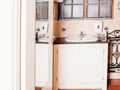 a bathroom with two sinks and two mirrors at Grace View Guest House in Secunda