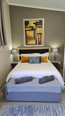 a bedroom with a large bed with two pillows on it at 189 Luxury Suite -Not availible anymore! in Centurion