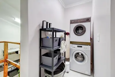 a laundry room with a washer and dryer at Luxurious self-catering villa, step-free and pet-friendly in Centurion