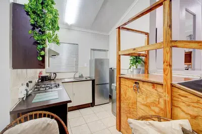 a kitchen with a sink and a stove top oven at Luxurious self-catering villa, step-free and pet-friendly in Centurion