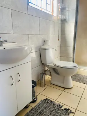 a bathroom with a toilet and a sink at Sisonke Guest House in Kwamhlanga