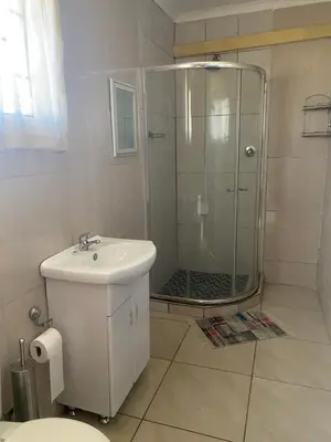 a bathroom with a shower and a toilet and a sink at Sisonke Guest House in Kwamhlanga