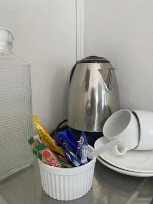 a tea pot and a cup on a counter at Sisonke Guest House in Kwamhlanga