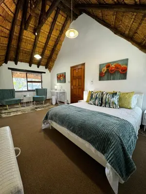 a bedroom with a large bed in a room at Blue Gum Cottage in Midrand