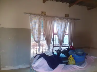 a room with a window and a pile of clothes at Southern Sun Hotels in Tongwe