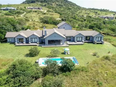 a large house on a hill with a swimming pool at Southern Sun Hotels in Tongwe