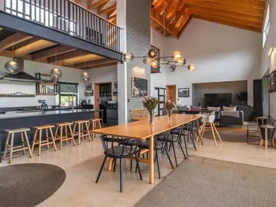 a dining room and kitchen with a table and chairs at Southern Sun Hotels in Tongwe