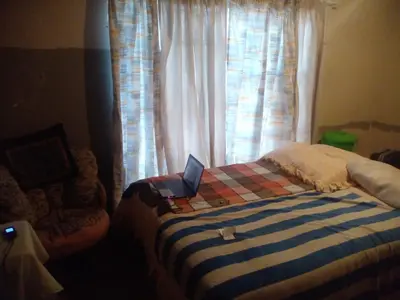 a bedroom with a bed with a laptop on it at Southern Sun Hotels in Tongwe