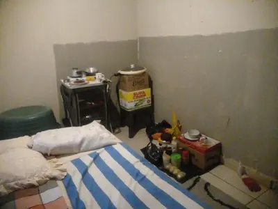 a messy bedroom with a bed and a box at Southern Sun Hotels in Tongwe