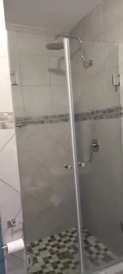 a shower with a glass door in a bathroom at Faerie Glen, No Loadshedding, Short or Long Stays, Fast Wi-Fi in Pretoria