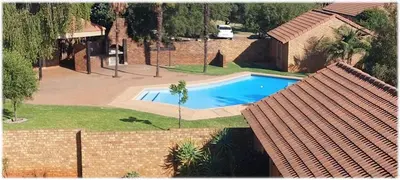 an overhead view of a swimming pool in a yard at Faerie Glen, No Loadshedding, Short or Long Stays, Fast Wi-Fi in Pretoria
