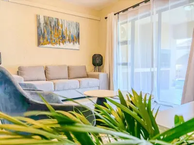 a living room with a couch and a window at Self checkin - Modern Haven 2 Bedroom 43 in Nelspruit