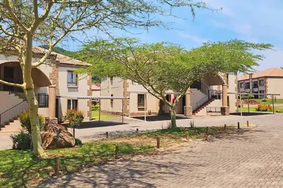 a building with trees and a brick road at Self checkin - Modern Haven 2 Bedroom 43 in Nelspruit