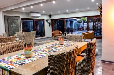 a dining room with a table and chairs at Siesta Manor Guesthouse in Mokopane