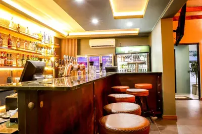 a restaurant with a bar with stools at Siesta Manor Guesthouse in Mokopane