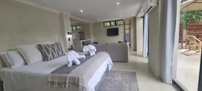 two teddy bears sitting on a couch in a living room at Buffalo Thorn Villa next to Kruger National Park in Marloth Park