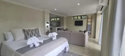 a bedroom with a bed with two stuffed animals on it at Buffalo Thorn Villa next to Kruger National Park in Marloth Park