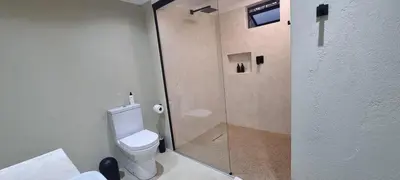 a bathroom with a toilet and a glass shower at Buffalo Thorn Villa next to Kruger National Park in Marloth Park