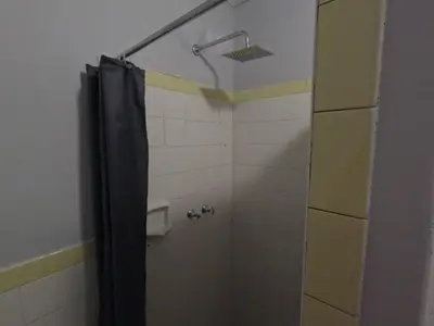 a shower with a black shower curtain in a bathroom at Aviation Stay in Kempton Park