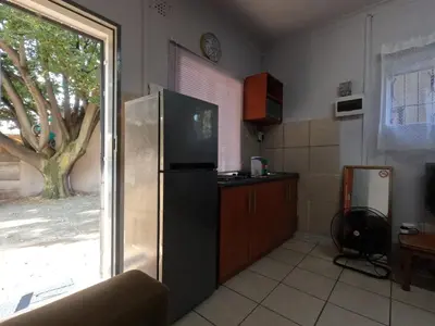 a kitchen with a stainless steel refrigerator and a window at Aviation Stay in Kempton Park