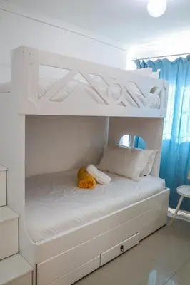 a white bunk bed with a yellow stuffed animal on it at Bonnie house in Crocodile Valley Estates