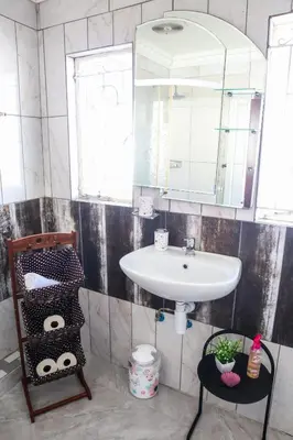 a bathroom with a sink and a mirror at Bonnie house in Crocodile Valley Estates