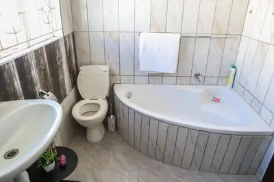 a bathroom with a tub and a toilet and a sink at Bonnie house in Crocodile Valley Estates
