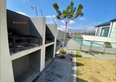 a backyard with a barbecue grill in a house at Ladybug ladybug in Midrand