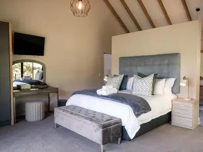 a bedroom with a large bed and a television at Whiskey Creek in Dullstroom