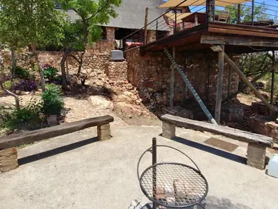 a bench sitting in front of a building at Sky Lodge in Hartbeespoort