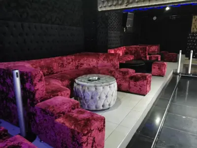 a room with pink couches and a table at Ebony Guest House in Pretoria