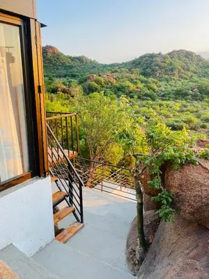 a balcony of a house with a view of a mountain at Makgobelo Lodge-The Glass House- Solar powered in Ga-Mokalapa