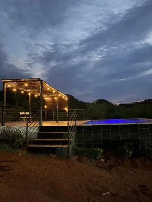 a lit up building with lights on it at night at Makgobelo Lodge-The Glass House- Solar powered in Ga-Mokalapa