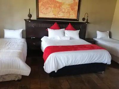 a hotel room with two beds with white and red pillows at Pioneer lodge in Lephalale