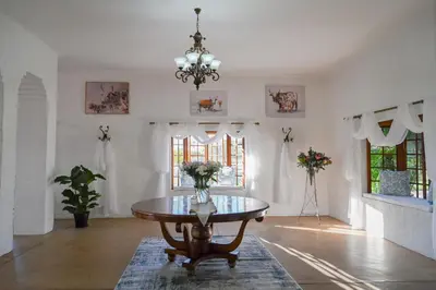 a dining room with a table and a chandelier at Pioneer lodge in Lephalale