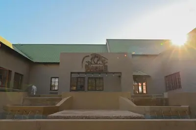 a building with a sign on the side of it at Pioneer lodge in Lephalale