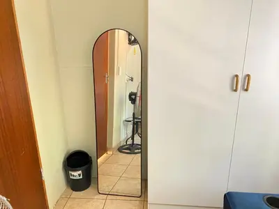 a mirror in the corner of a room at c and c guest house pretoria north in Pretoria
