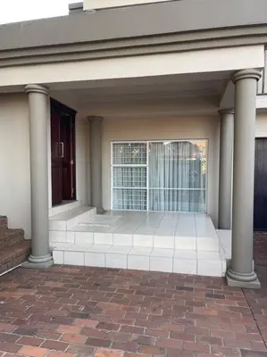 a front porch of a house with columns at Red Cascade - Luxury 4 bedrooms -solar and aircons in Hartbeespoort