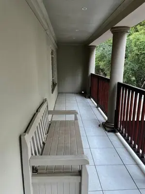 a porch with a bench on a house at Red Cascade - Luxury 4 bedrooms -solar and aircons in Hartbeespoort