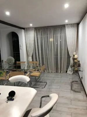 a room with a table and chairs and a room with windows at Red Cascade - Luxury 4 bedrooms -solar and aircons in Hartbeespoort