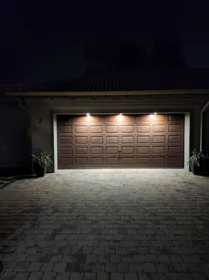 a garage door with lights on it at night at Studio in Lynnwood garden estate in Pretoria