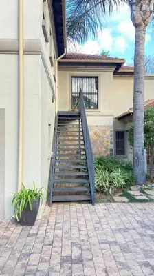 a house with a staircase in front of a house at Studio in Lynnwood garden estate in Pretoria