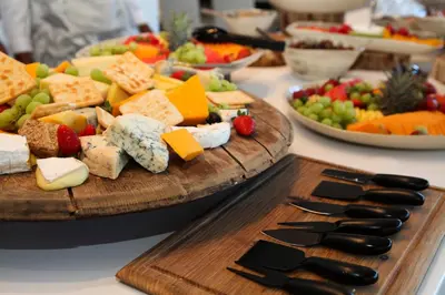 a table with a plate of cheese and other foods at Wildside Safari Camp in Golders Green