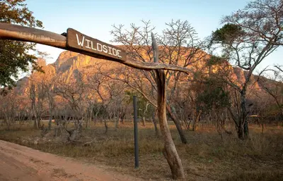a street sign on the side of a dirt road at Wildside Safari Camp in Golders Green