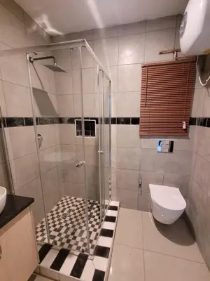 a bathroom with a shower and a toilet at Okoli's Place in Sandown