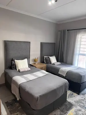 two beds in a hotel room with two beds at Large 3 Bedroom Apartment in Midrand, Waterfall City - More space than a hotel room - Ideal for families, groups and work trips - 18A Elizabeth Place in Midrand