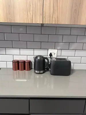 a tea kettle and a toaster on a kitchen counter at Large 3 Bedroom Apartment in Midrand, Waterfall City - More space than a hotel room - Ideal for families, groups and work trips - 18A Elizabeth Place in Midrand